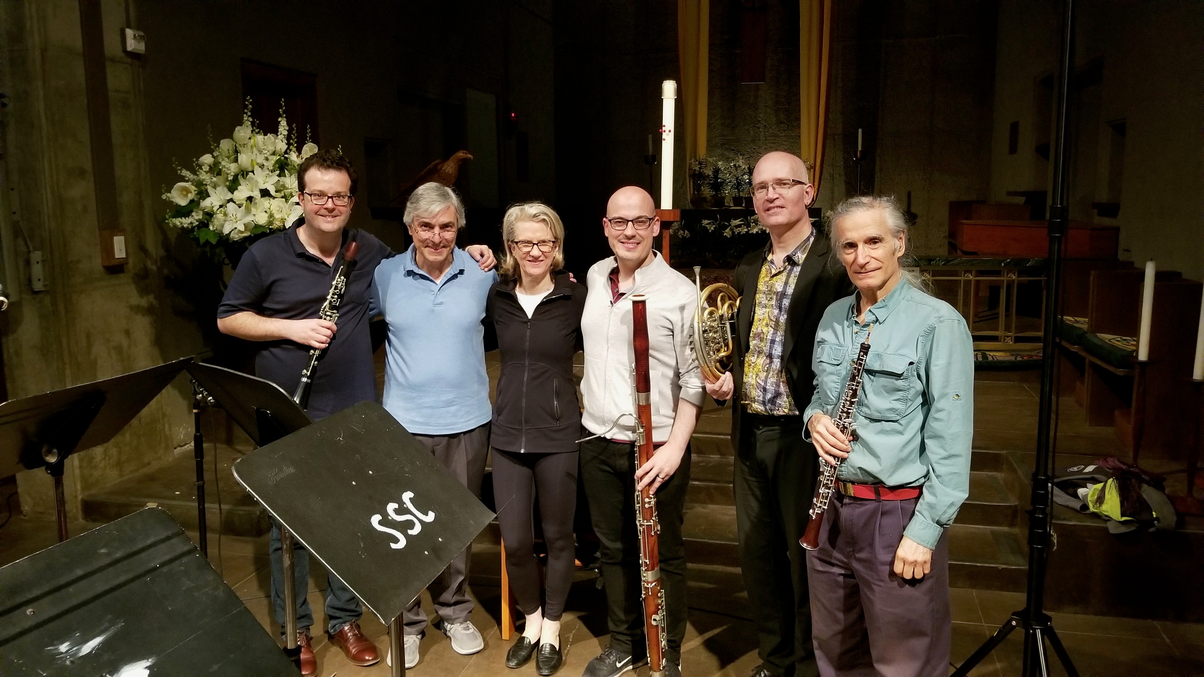 Six musicians with wind instruments after recording Times of Day